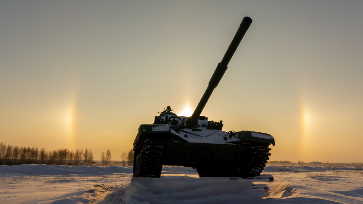 Modern military tank on the background of a solar halo effect.