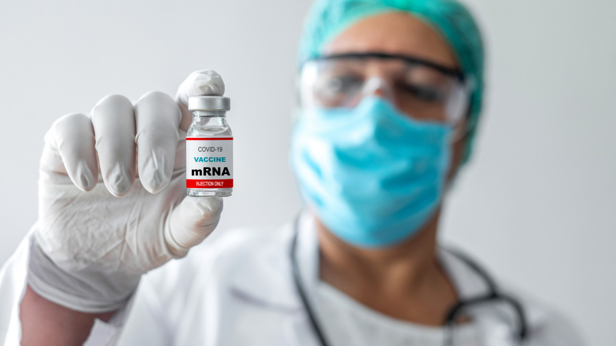 Doctor holding mRNA vaccine